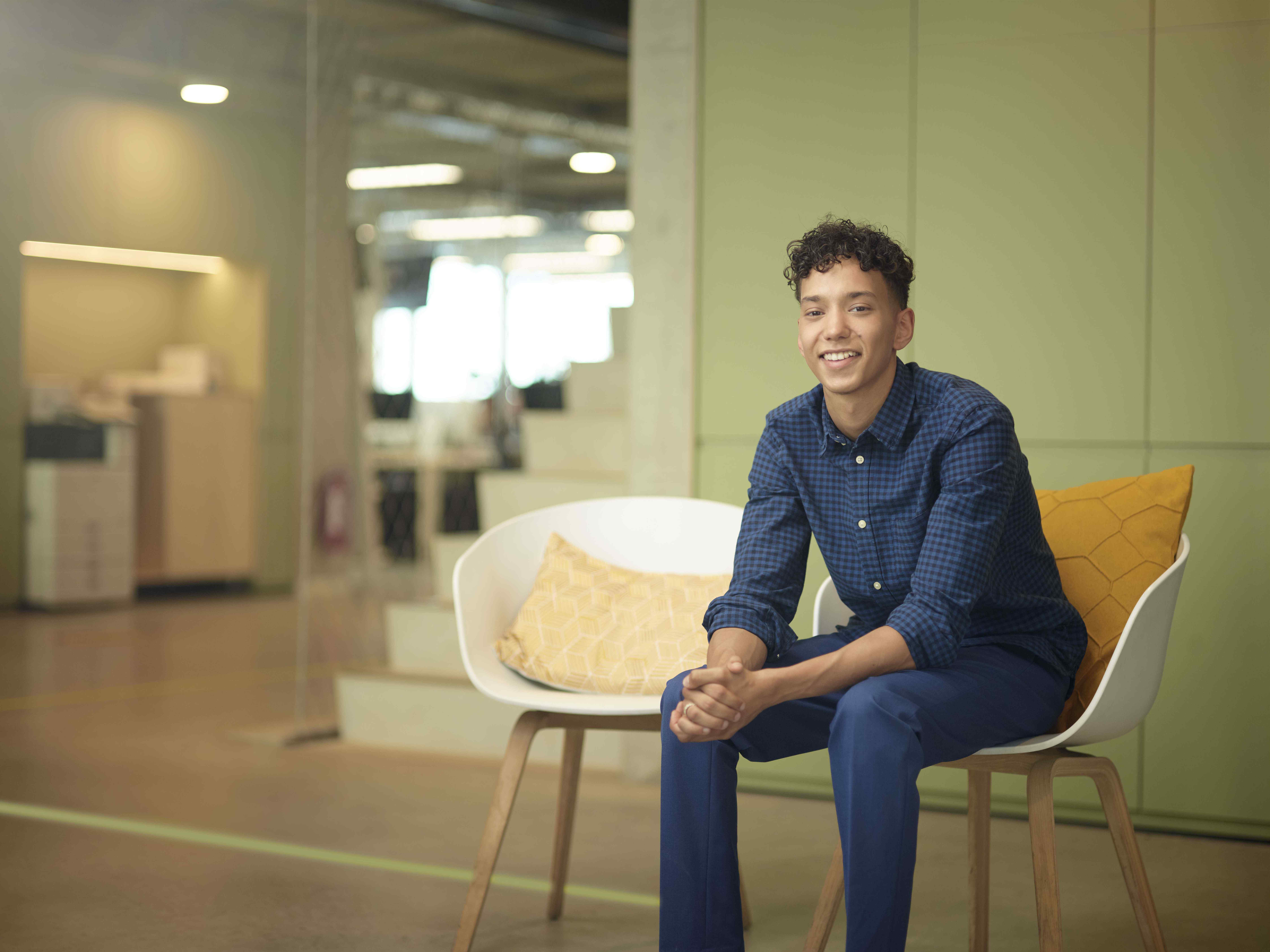 Accountmanager zit in stoel en lacht 